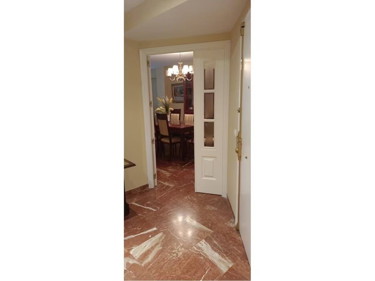 Una puerta que conduce a un comedor con una mesa y sillas.