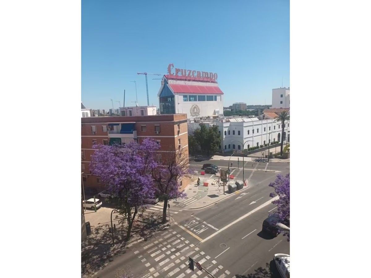 Una vista aérea de una calle de la ciudad con un gran edificio al fondo.