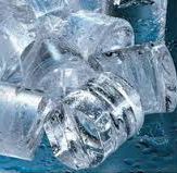 Primer plano de cubitos de hielo transparentes, algunos con burbujas de aire visibles, sobre una superficie de tono azul.