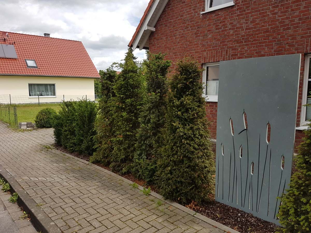 eine Reihe von Bäumen , die neben einem Backsteinhaus stehen - Traumgärten Benjamin Biermeyer aus Soest