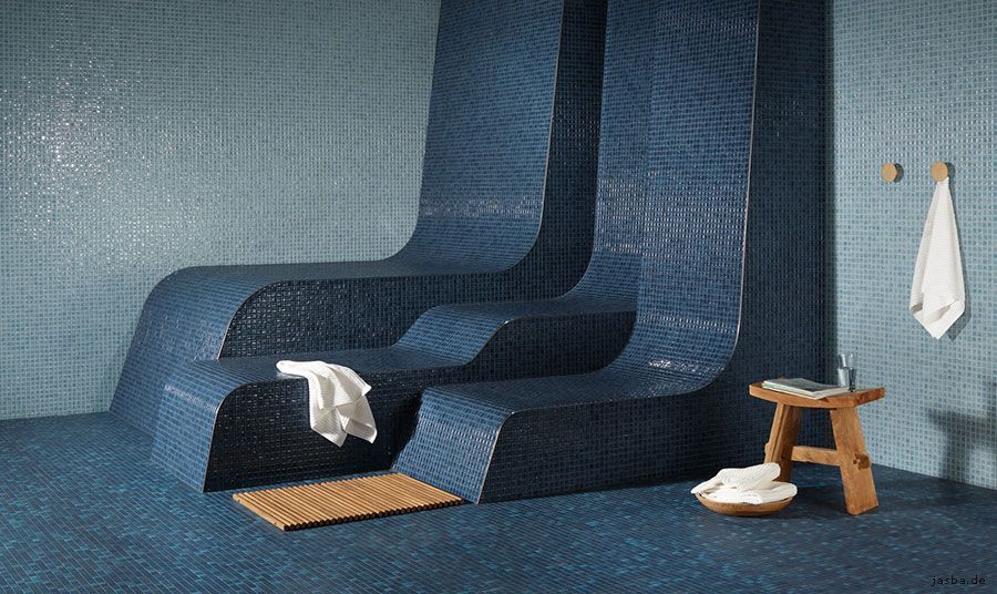 Ein Badezimmer mit zwei blauen Stühlen und einem Holzhocker