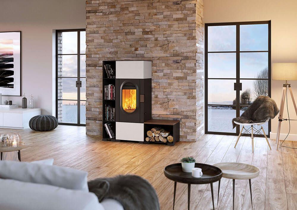 Ein Wohnzimmer mit Sofa, Sessel, Tischen und Kamin.