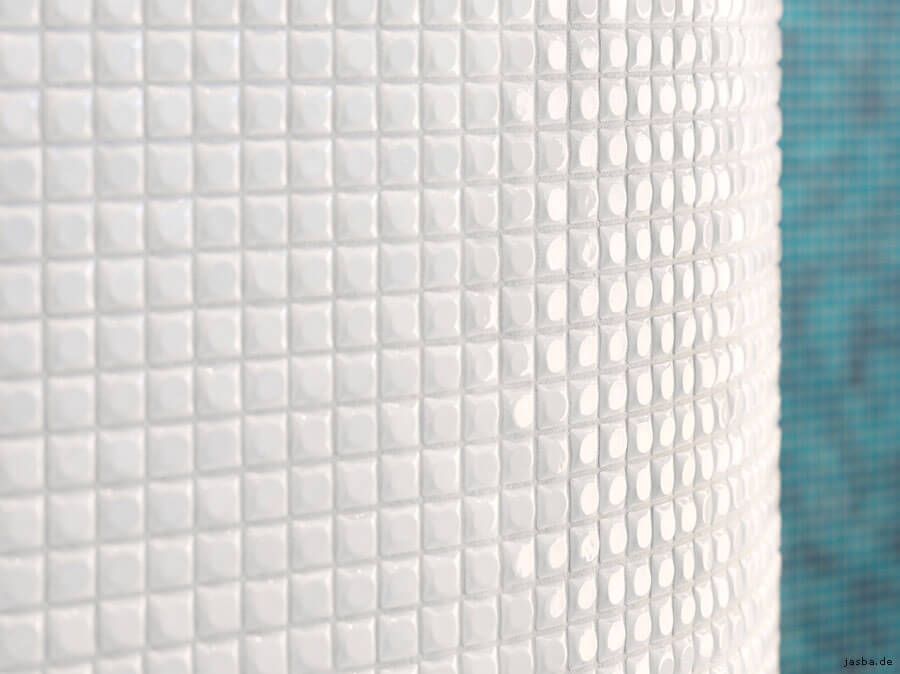 Eine Nahaufnahme einer weiß gefliesten Wand mit blauem Hintergrund.