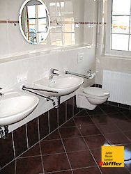 Ein Badezimmer mit zwei Waschbecken und einer Toilette.