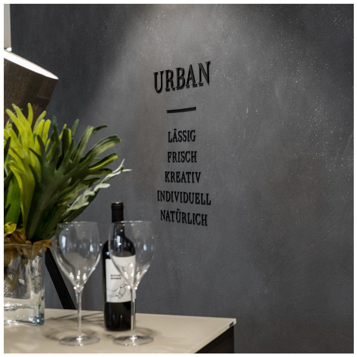Anthrazitfarbene Wand mit Schriftzug in einem Restaurant