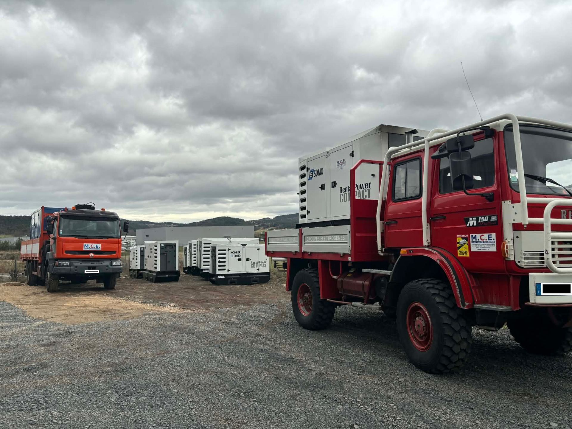 Un camion orange qui transporte des groupes électrogène