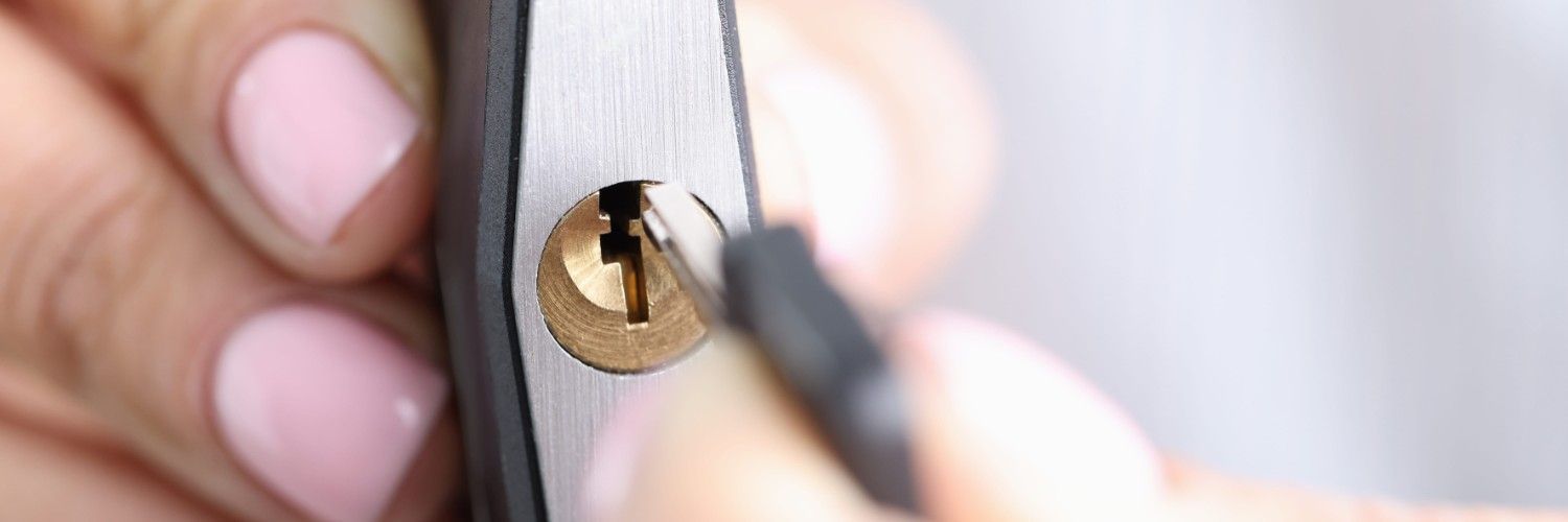 Una persona está arreglando una cerradura de puerta con una llave.
