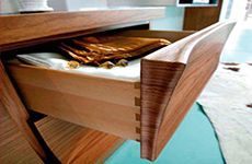 Un primer plano de un cajón de madera con una manta dentro.