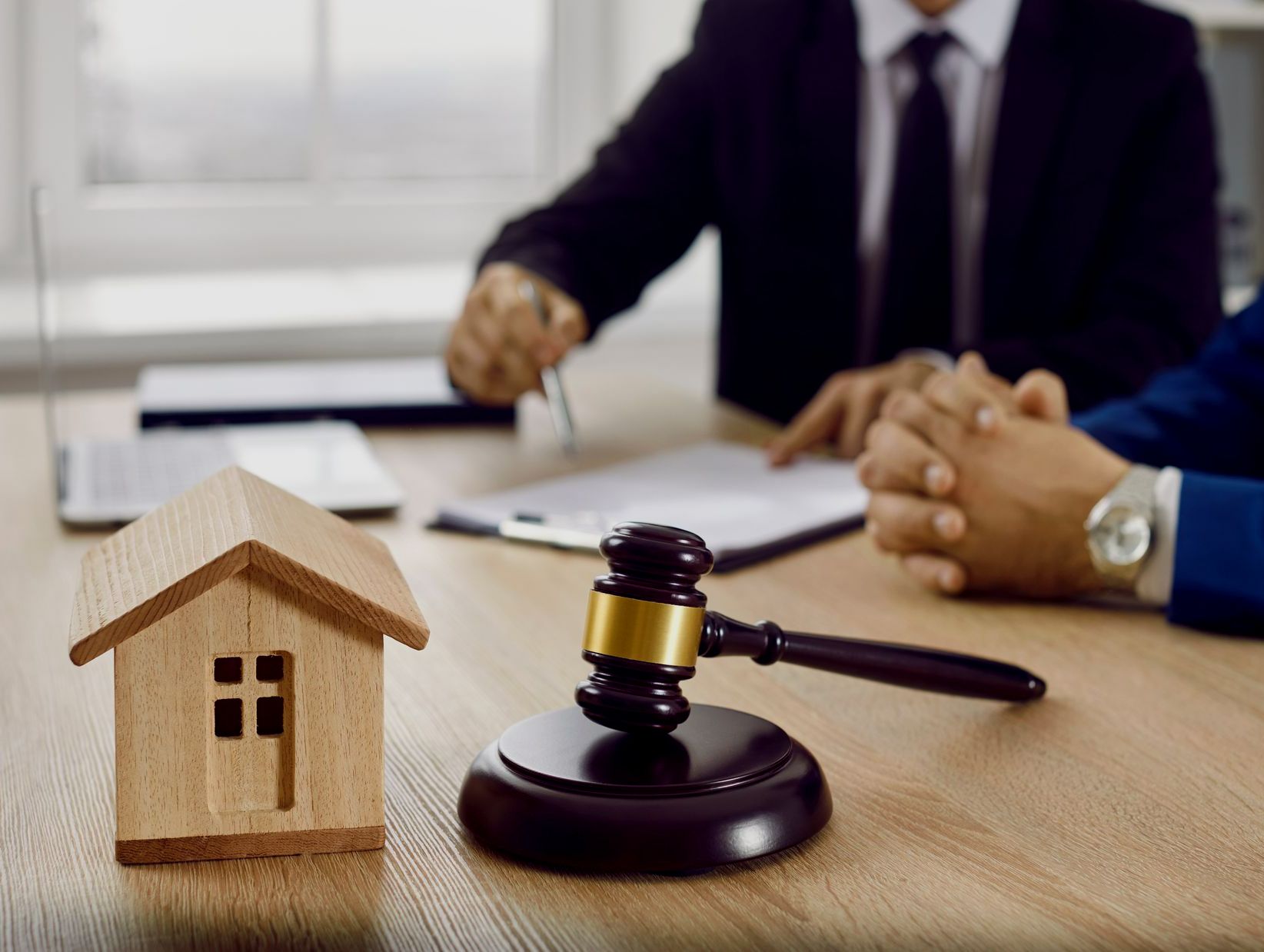 Petite maison en bois et marteau sur une table