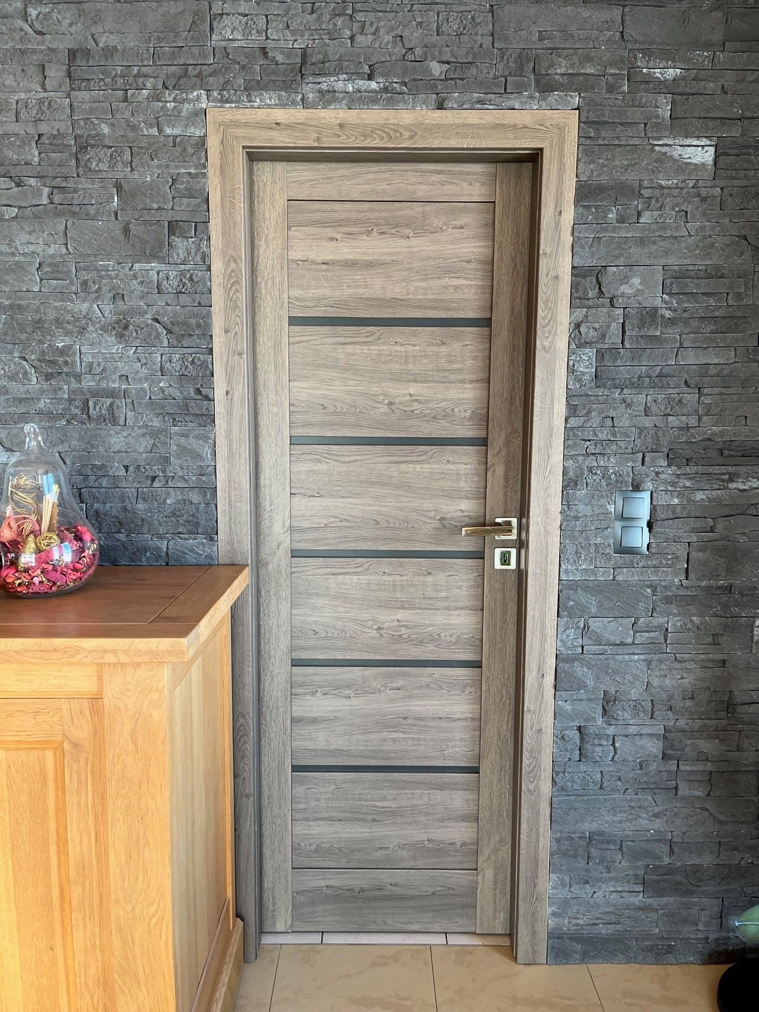 Porte en bois avec un mur en pierres grises