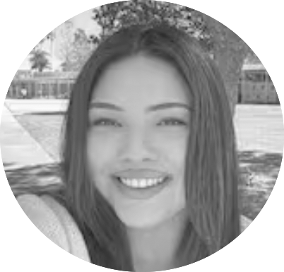 Smiling person with long hair in an outdoor park setting