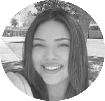 Smiling person with long hair in an outdoor park setting