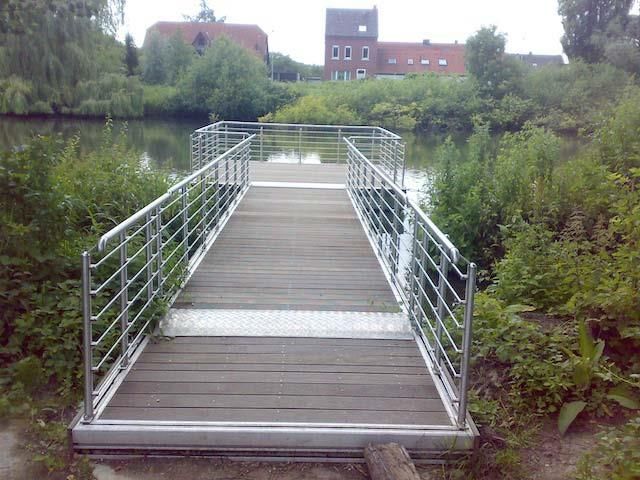 Eine Brücke über ein Gewässer mit einem Gebäude im Hintergrund