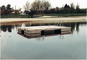 Ein Holzsteg schwimmt mitten auf einem See.