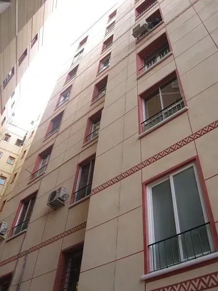 Mirando hacia arriba a un edificio alto con muchas ventanas