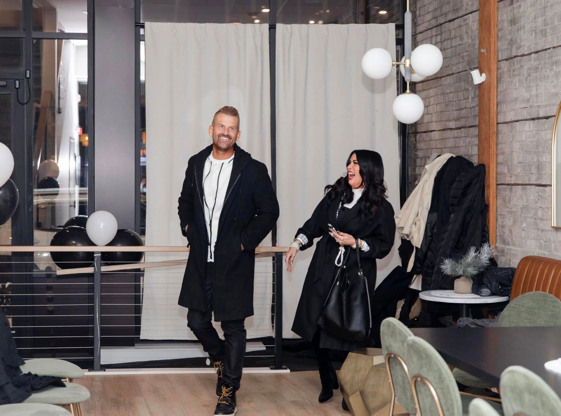 A man and a woman are standing next to each other in a room.