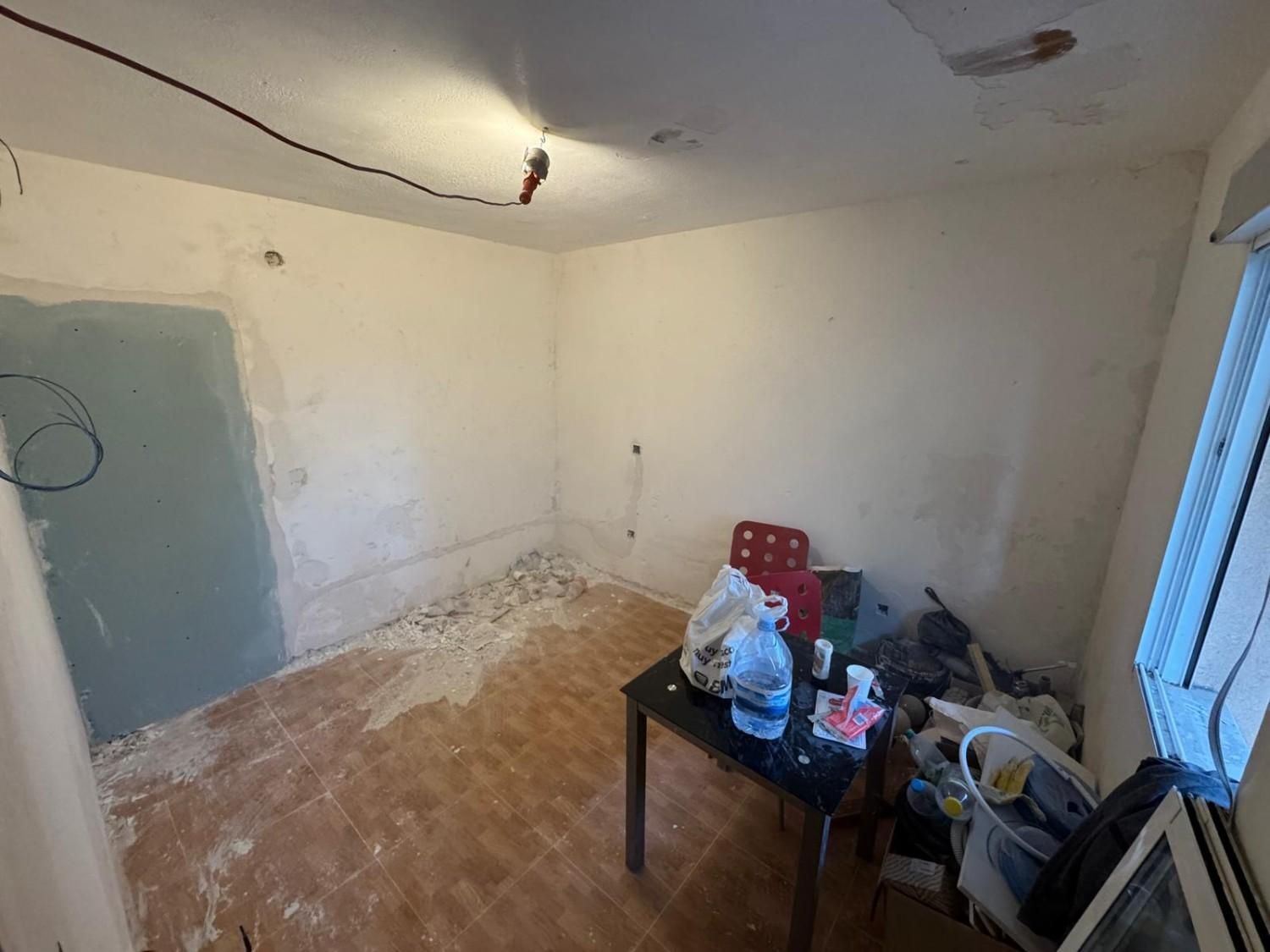 Una habitación pequeña y sin terminar, con paredes de color claro