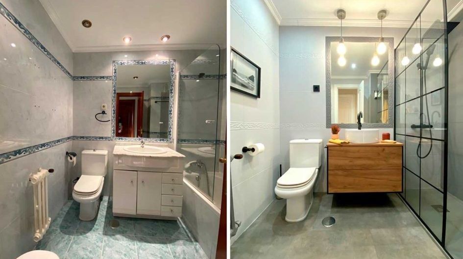 Un trabajador de la construcción con equipo de protección blanco pinta una pared, sonriendo, en una habitación en renovación.