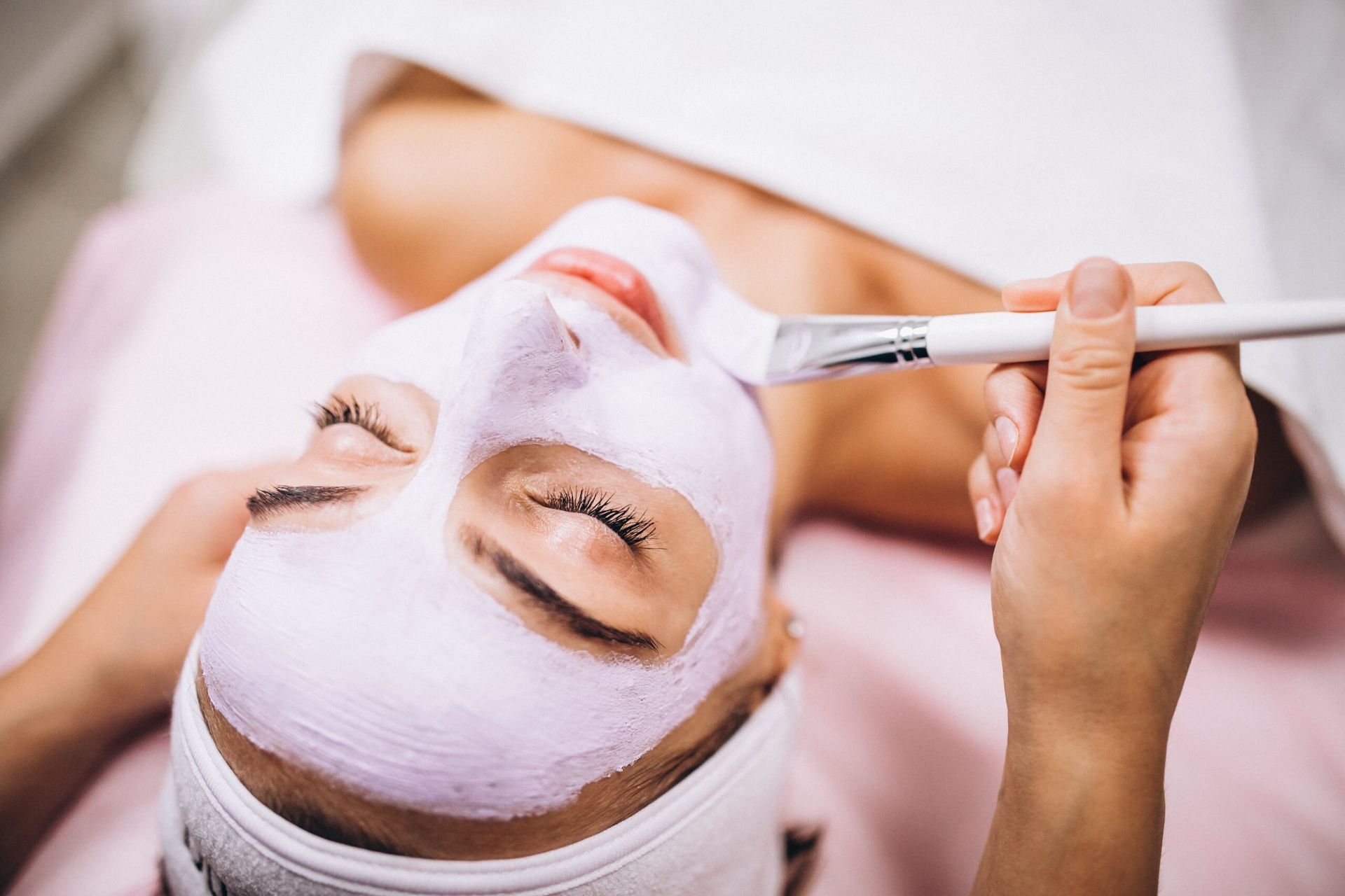 Una mujer está recibiendo un tratamiento facial en un spa.