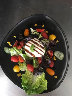 Assiette noire avec une entrée