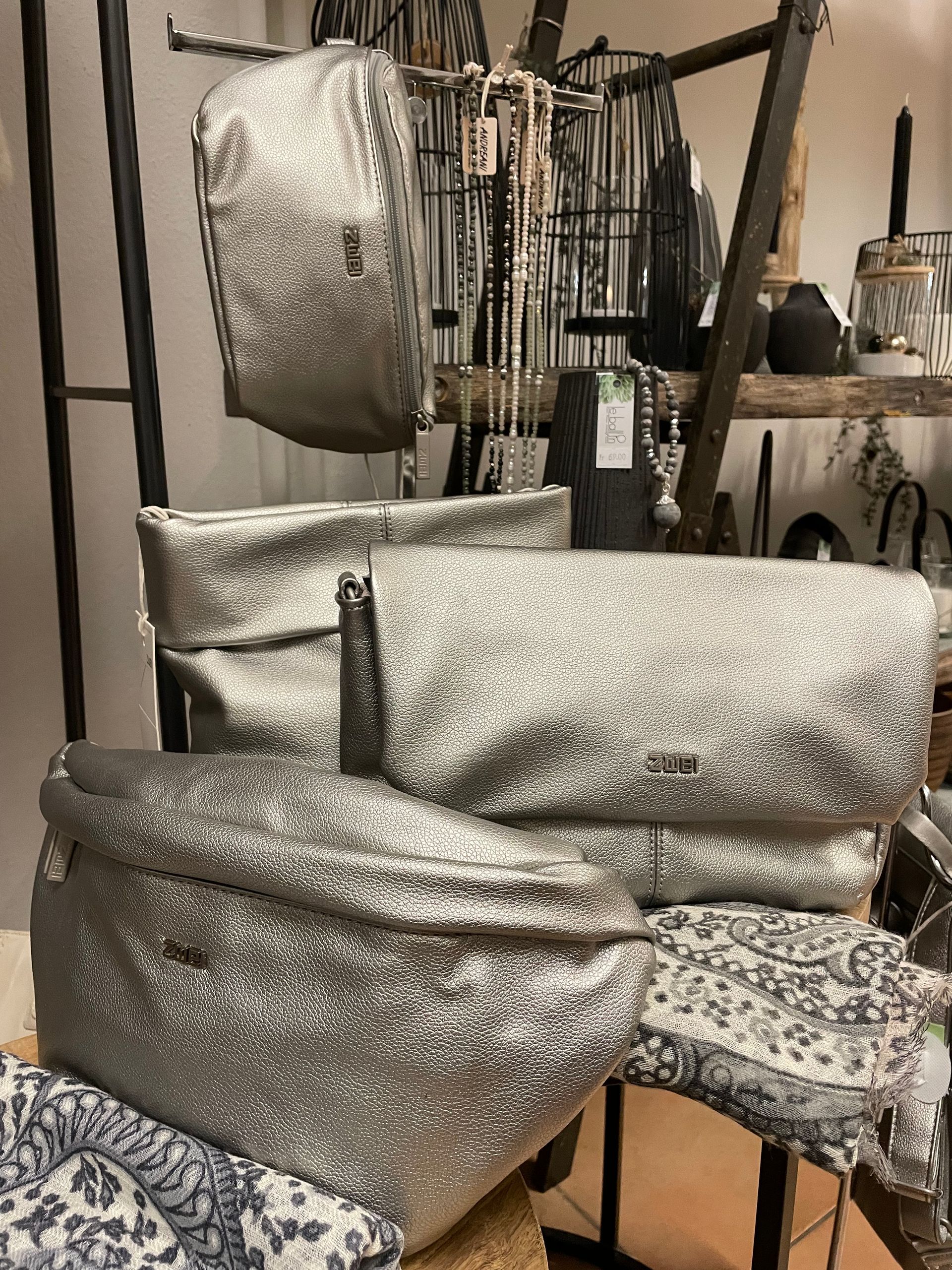 Ein Stapel silberner Taschen, der übereinander auf einem Tisch liegt.