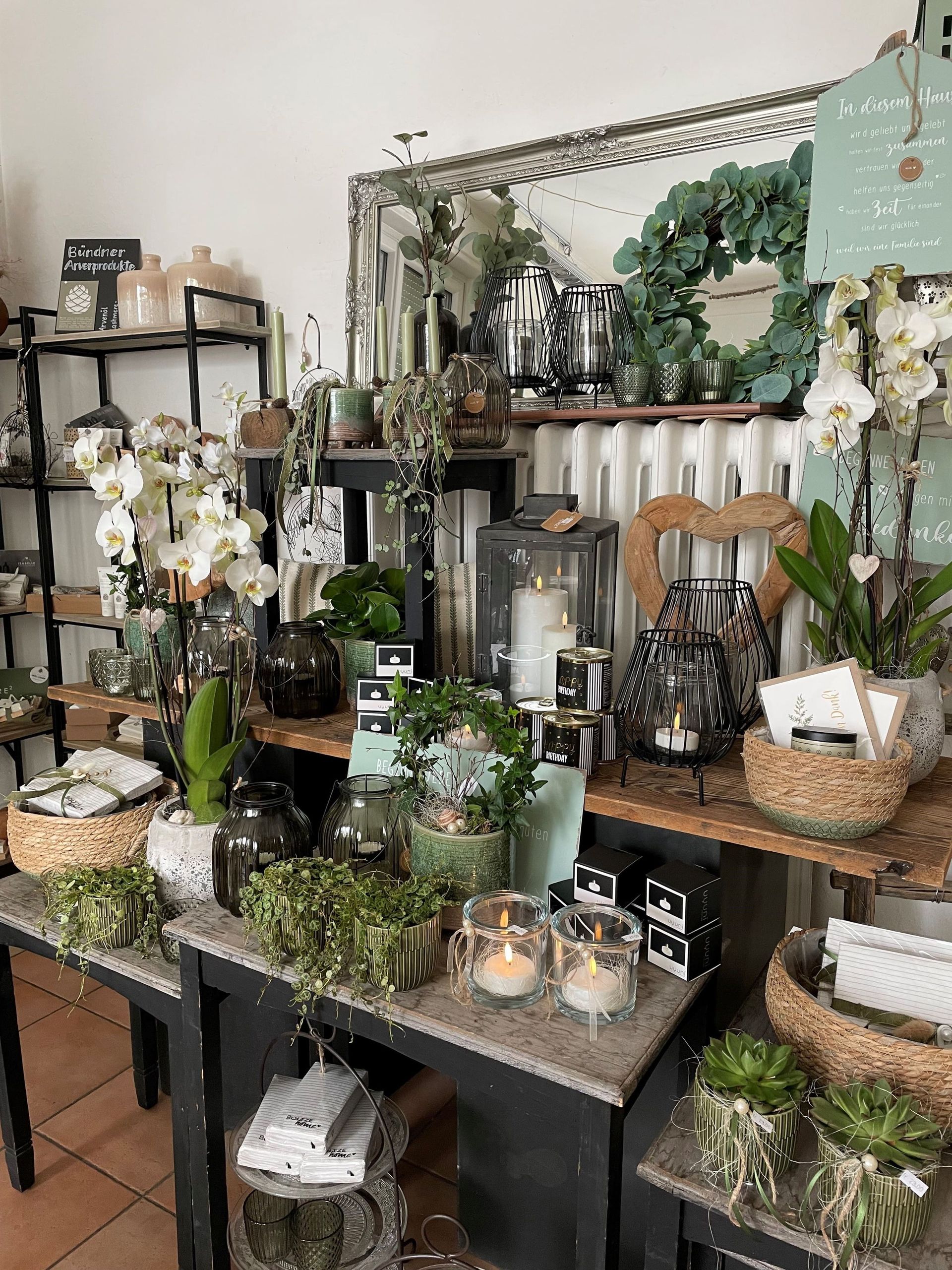 Ein Raum voller Blumen und Kerzen auf den Tischen.