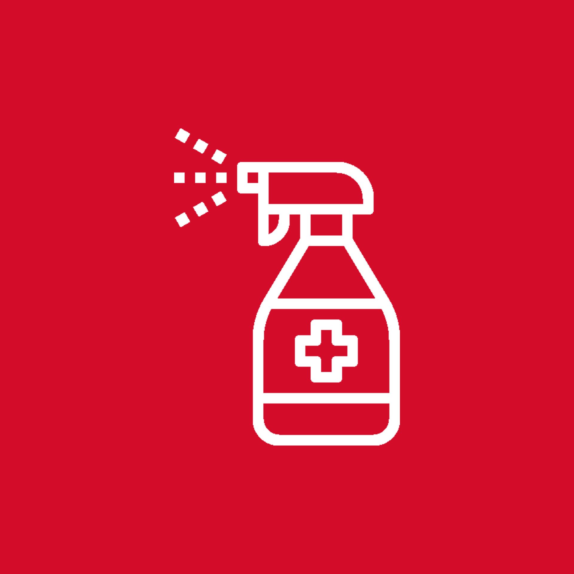 Eine Sprühflasche mit einem Kreuz darauf befindet sich auf rotem Hintergrund.