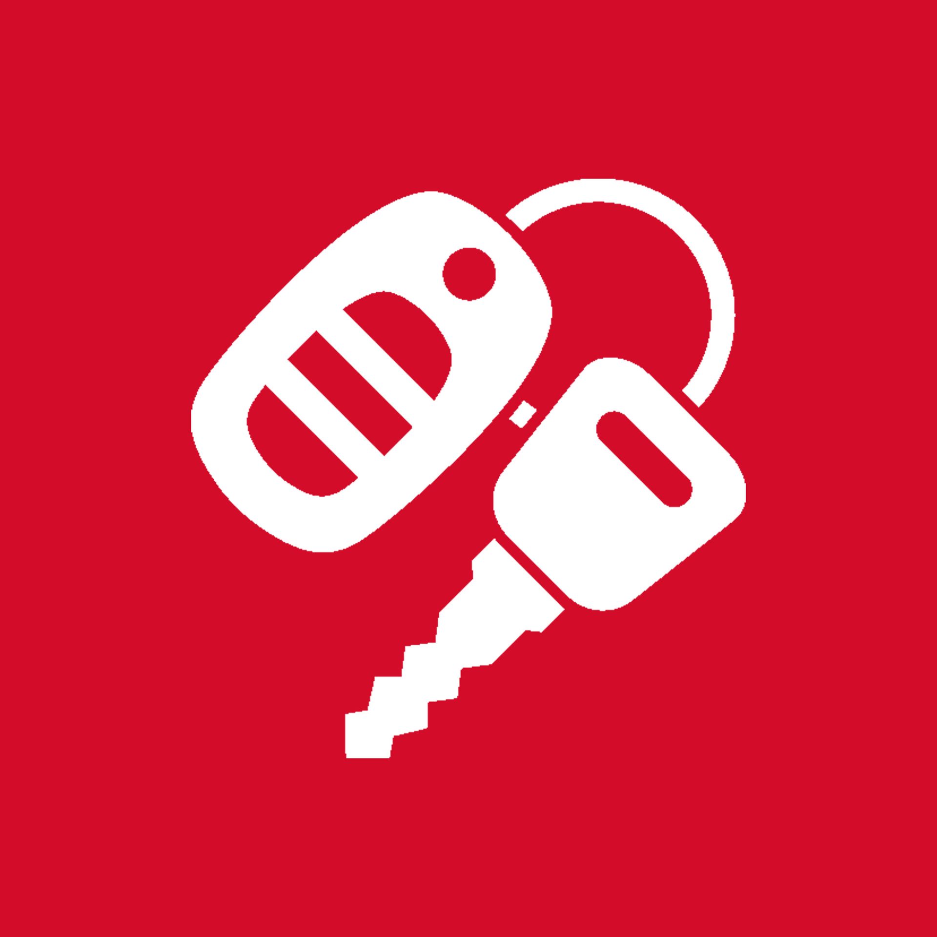 Ein Paar Autoschlüssel auf rotem Hintergrund.