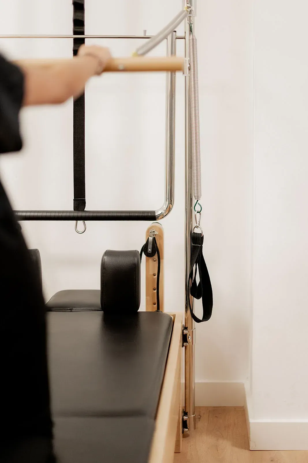 Una persona está utilizando una máquina de pilates en un gimnasio.