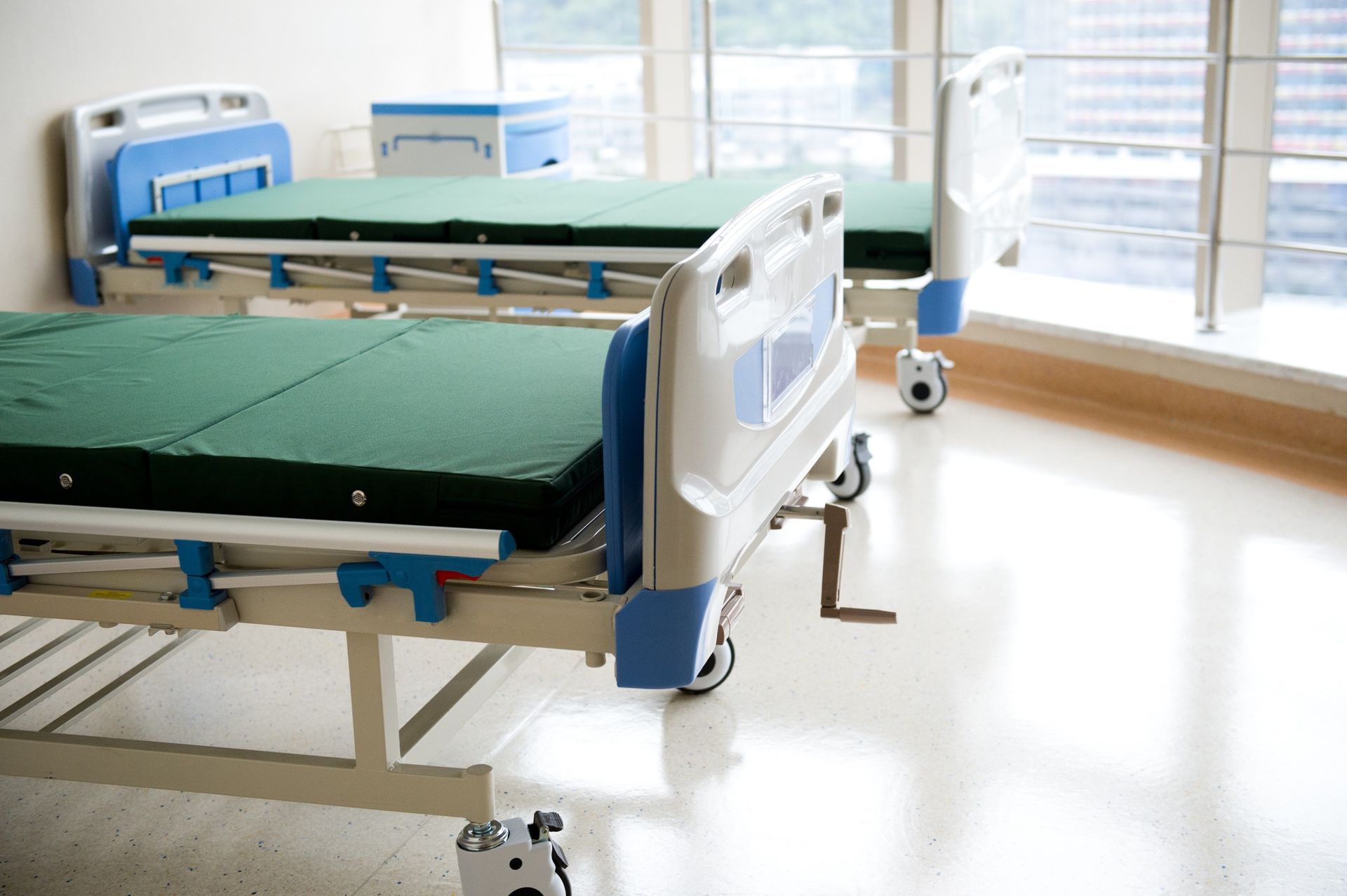 Dos camas de hospital están una al lado de la otra en una habitación vacía.