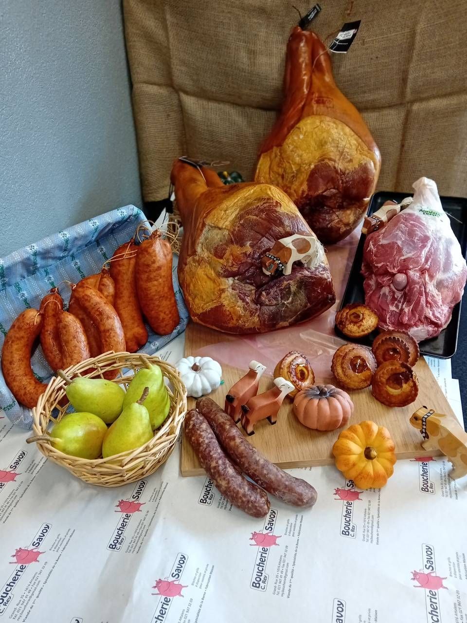 Une table garnie de charcuterie, jambons et saucisses.