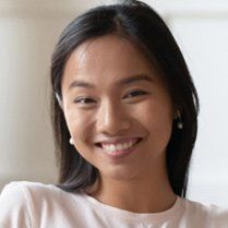 A close up of a woman 's face smiling.