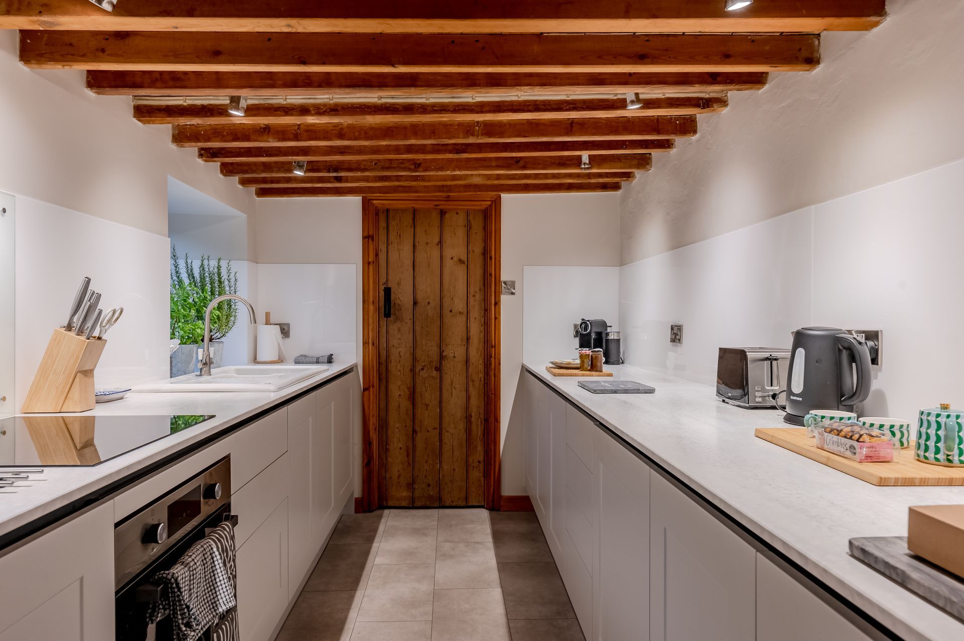 Modern kitchen with washer dryer in utility room 