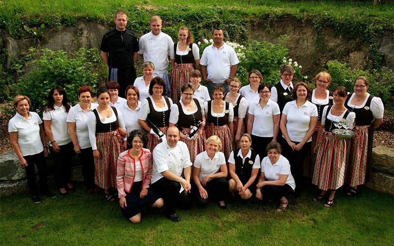 A photo of the whole team standing in the garden of the hotel
