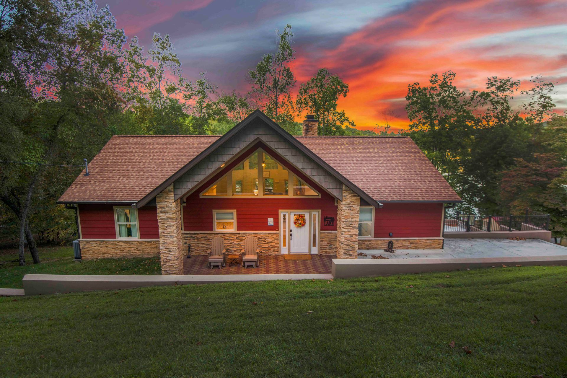 A red house with a sunset in the background