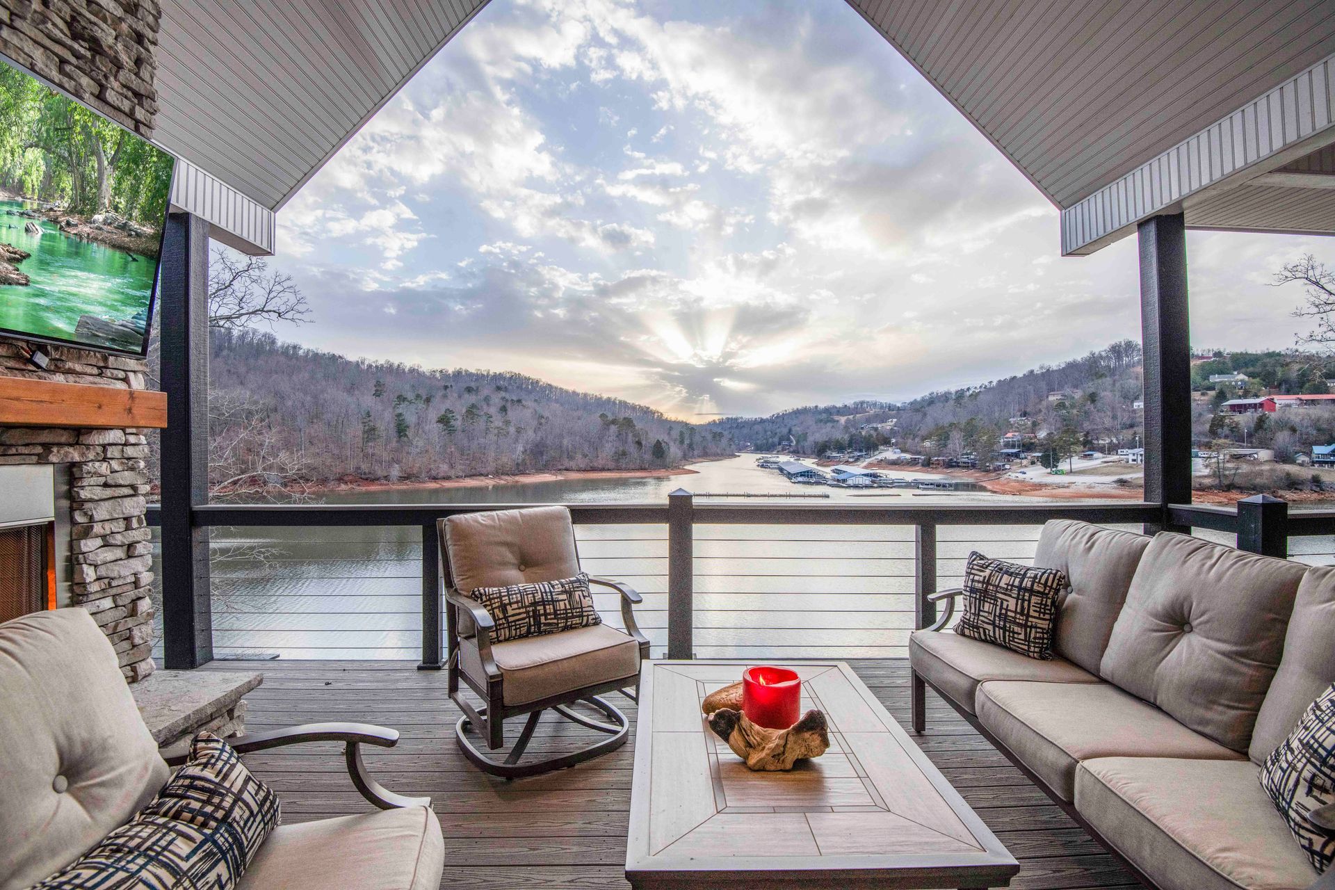 A patio with a view of a lake and mountains.