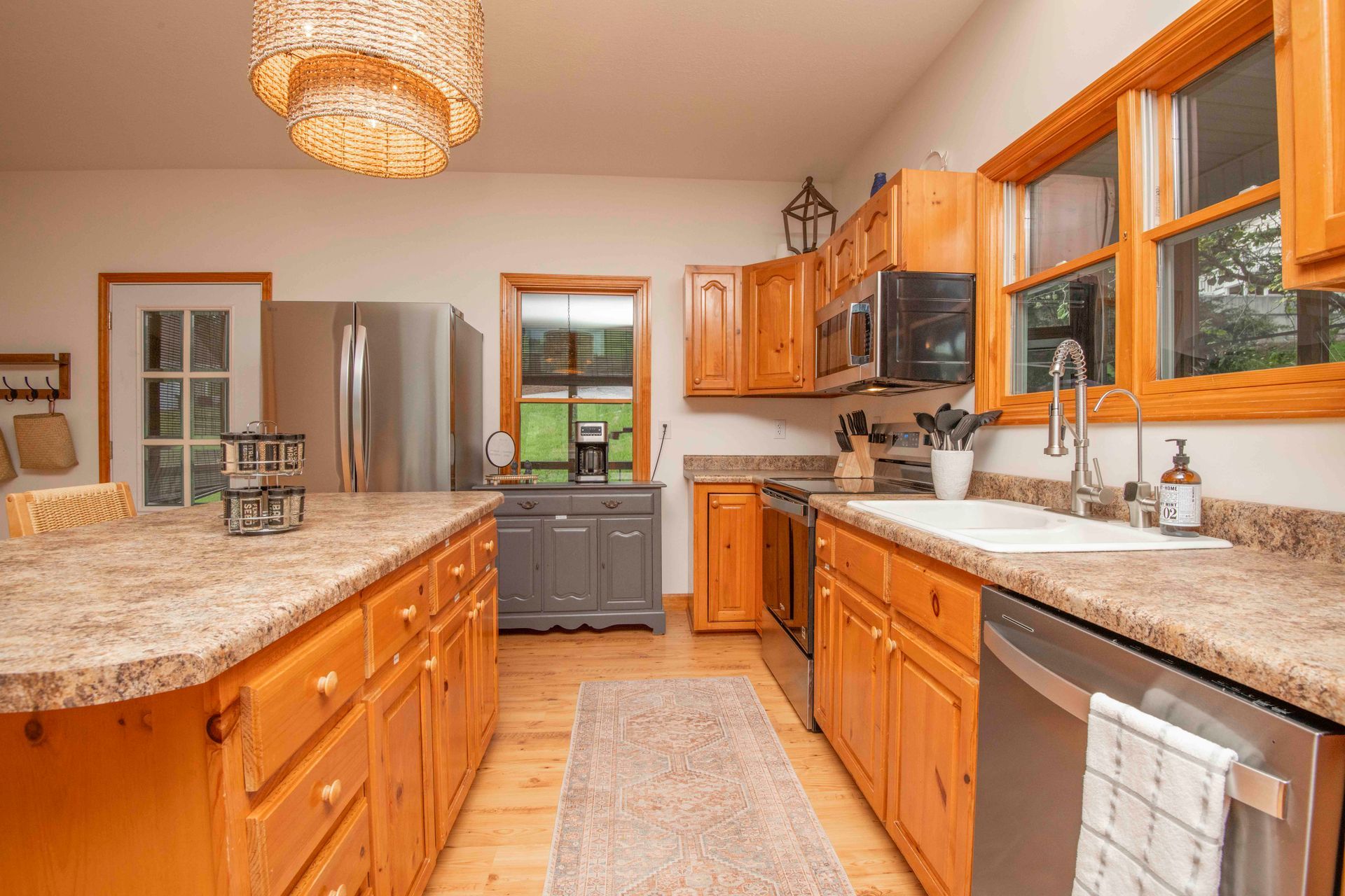 Kitchen with wooden cabinets, stainless steel appliances, and a granite countertop.
