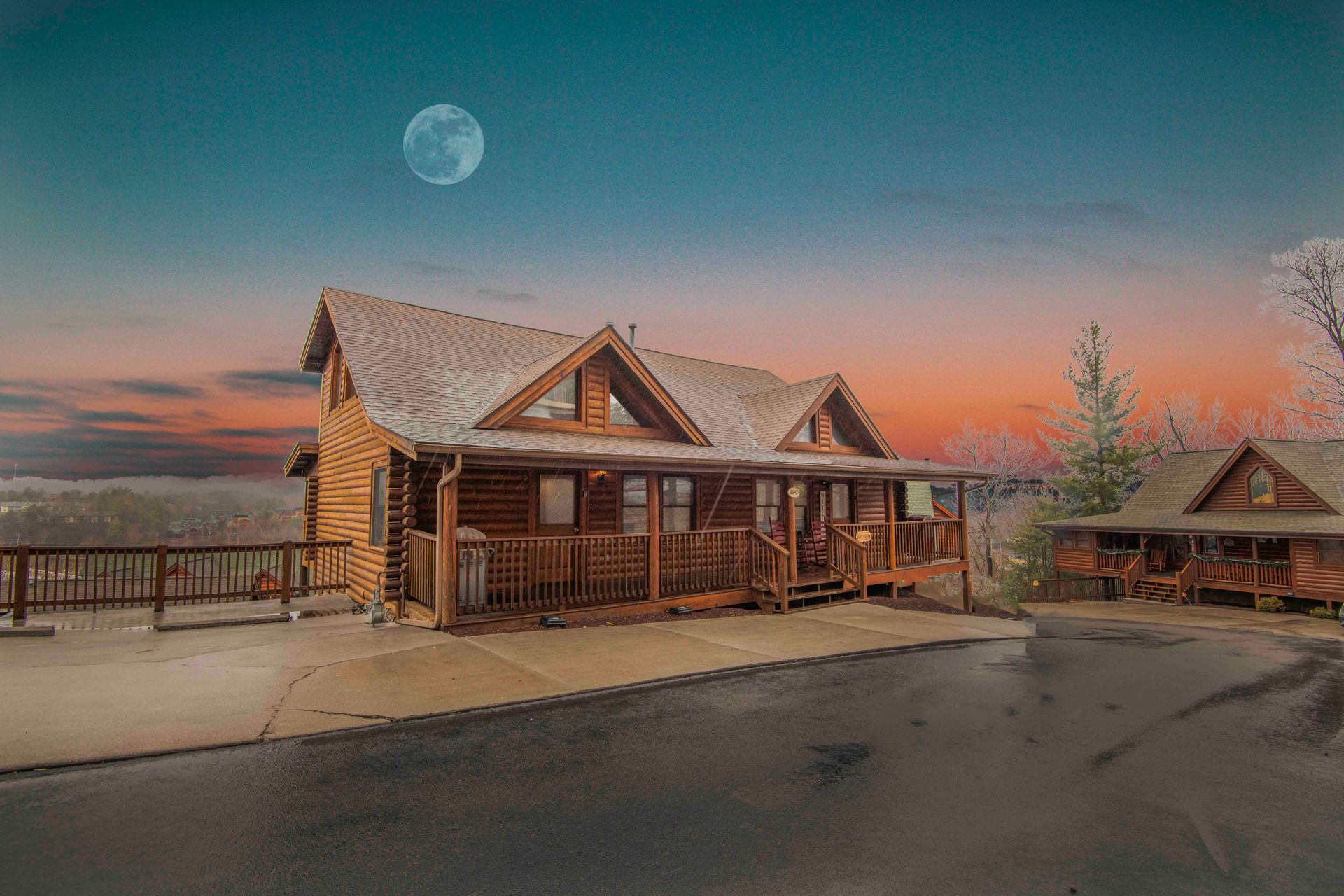 A log cabin with a full moon in the background at sunset. Pigeon Forge Rentals
