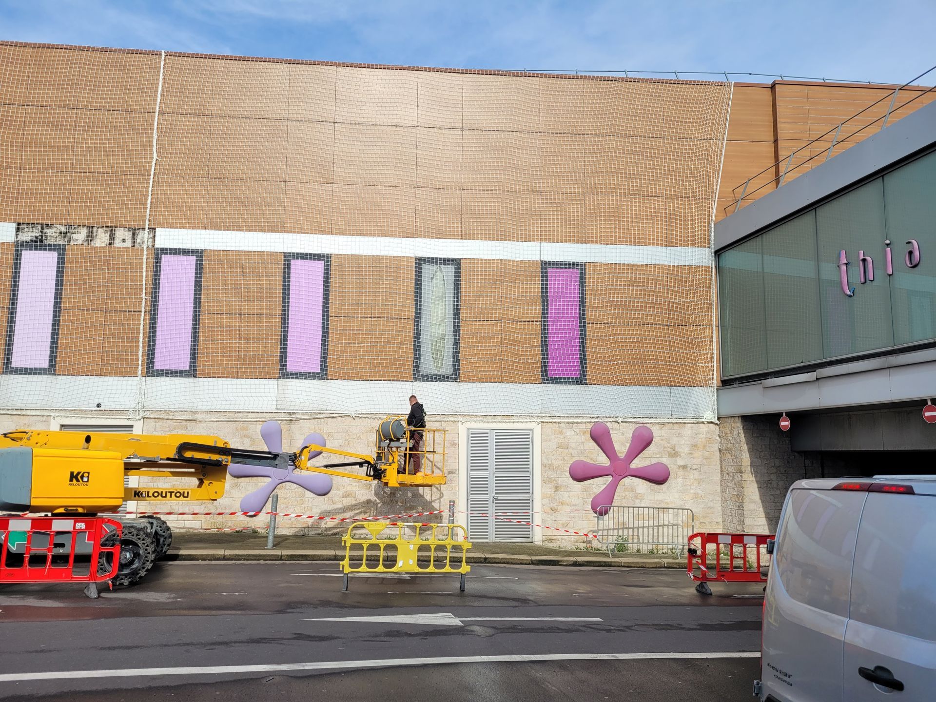 Façade d'immeuble en rénovation, avec un filet de sécurité en façade.