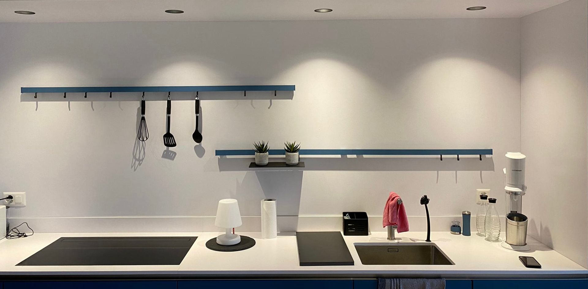 A kitchen with a stove top oven and a sink