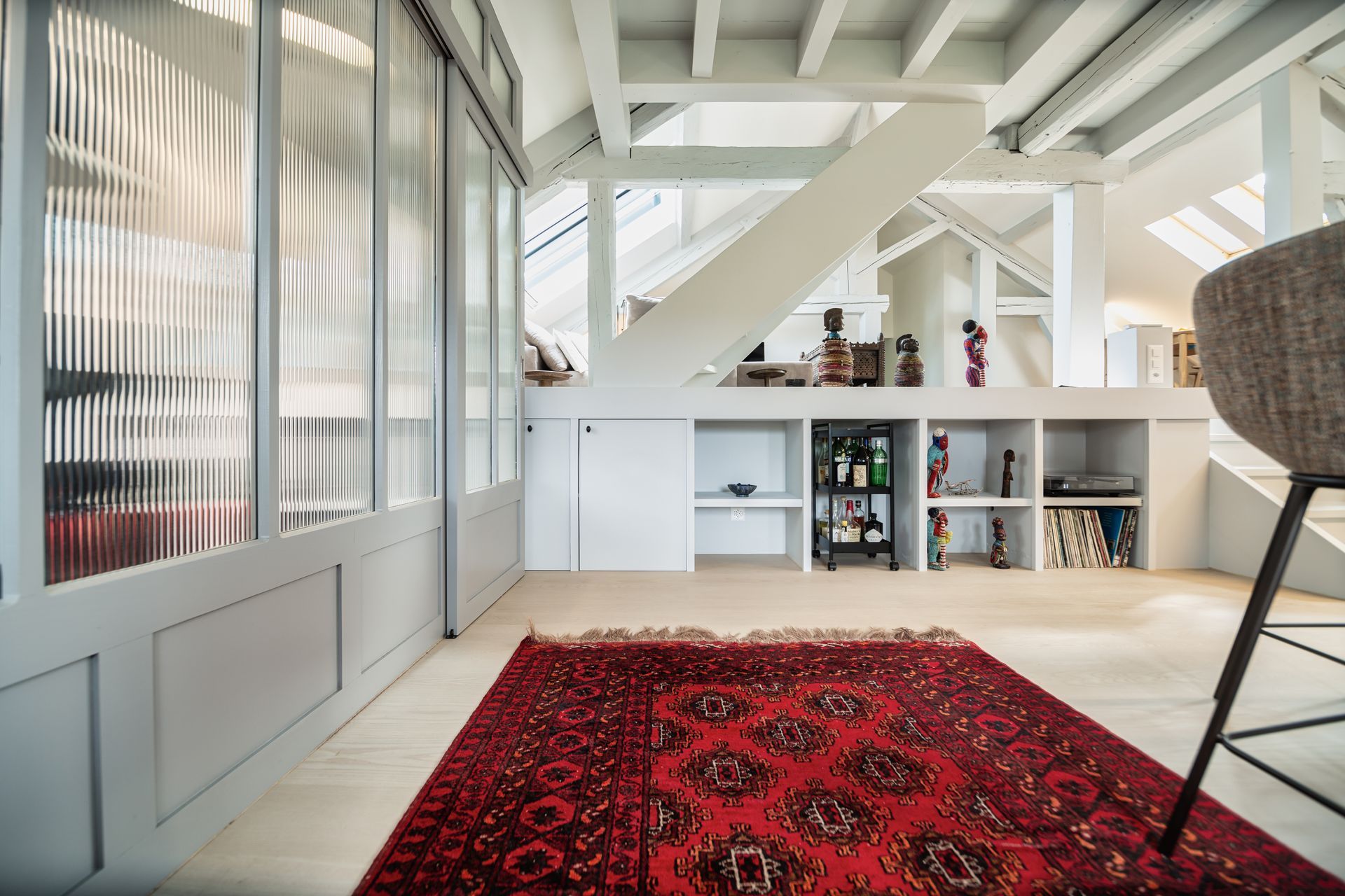 There is a red rug in the middle of the room.
