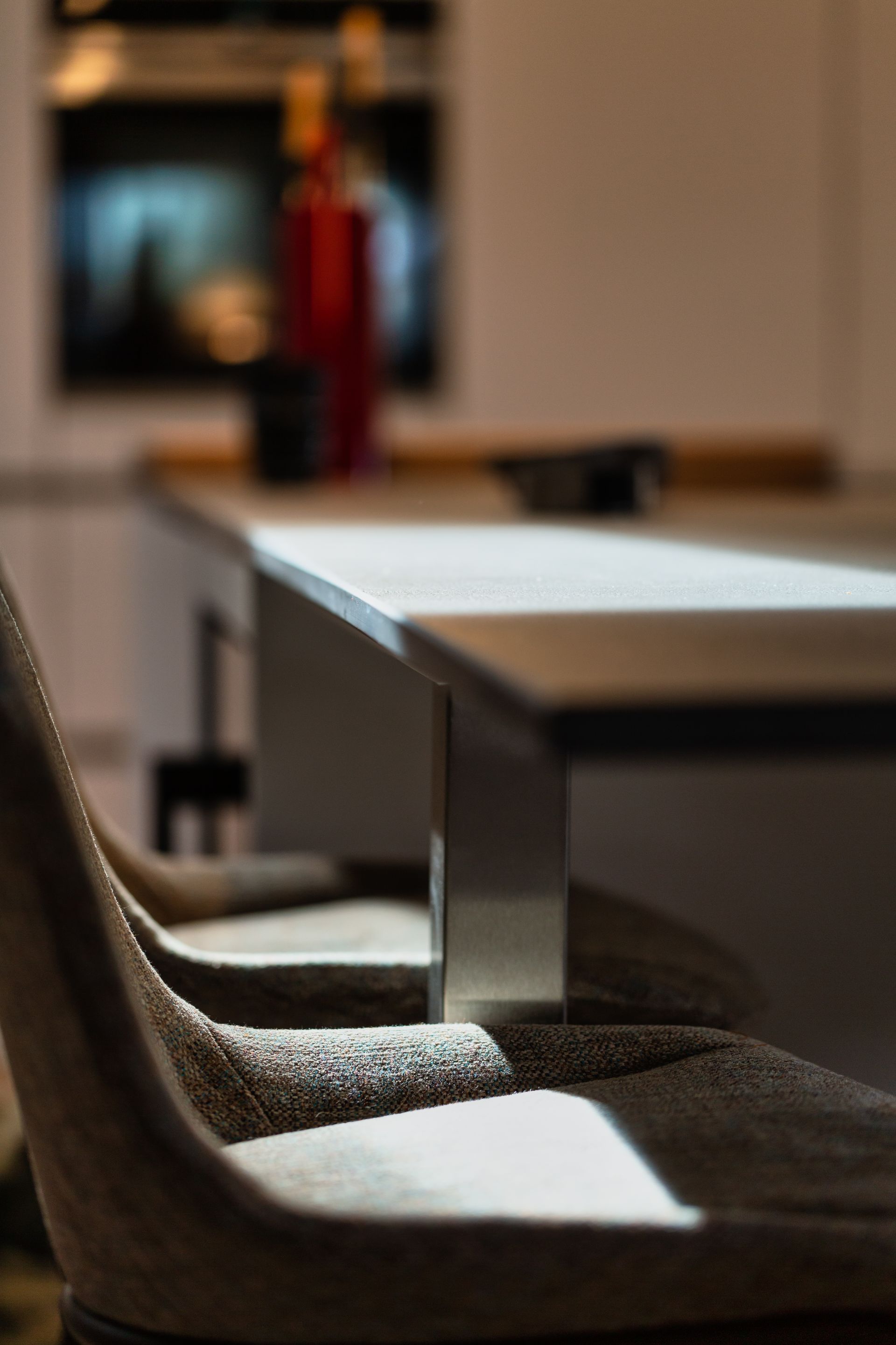 A chair is sitting in front of a table in a kitchen
