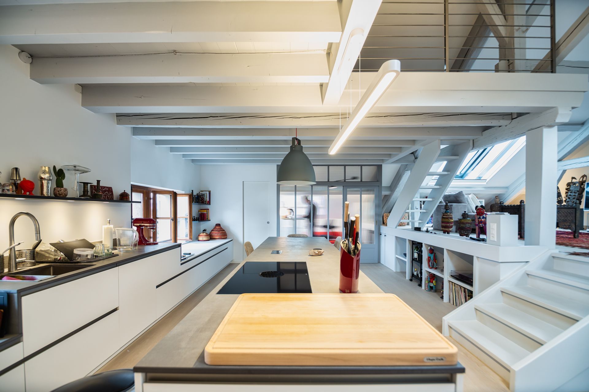 A kitchen with a large wooden table in the middle of it.