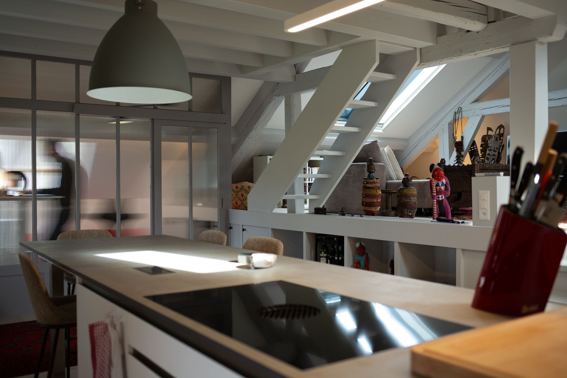 A kitchen with a stove top oven and a cutting board