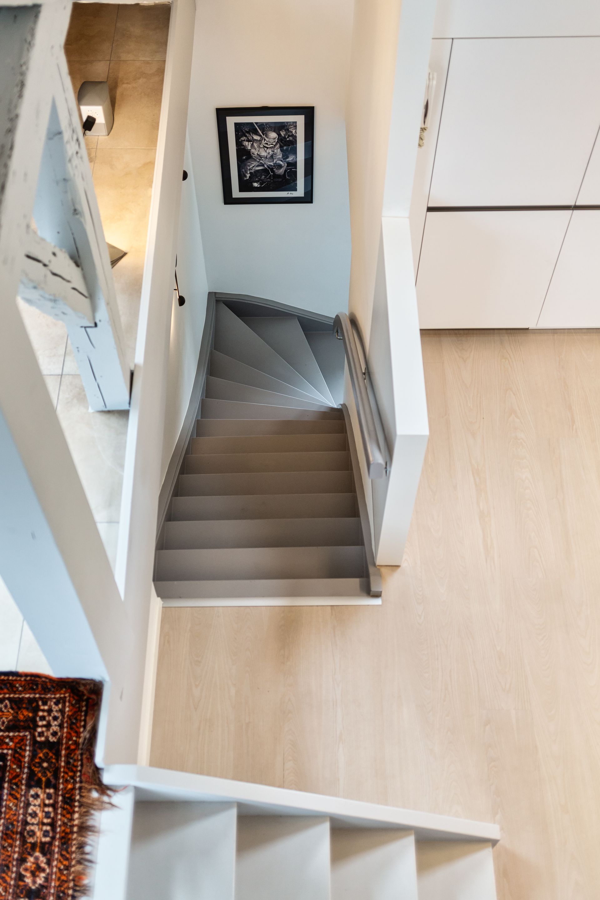 An aerial view of a staircase leading up to the second floor of a house.
