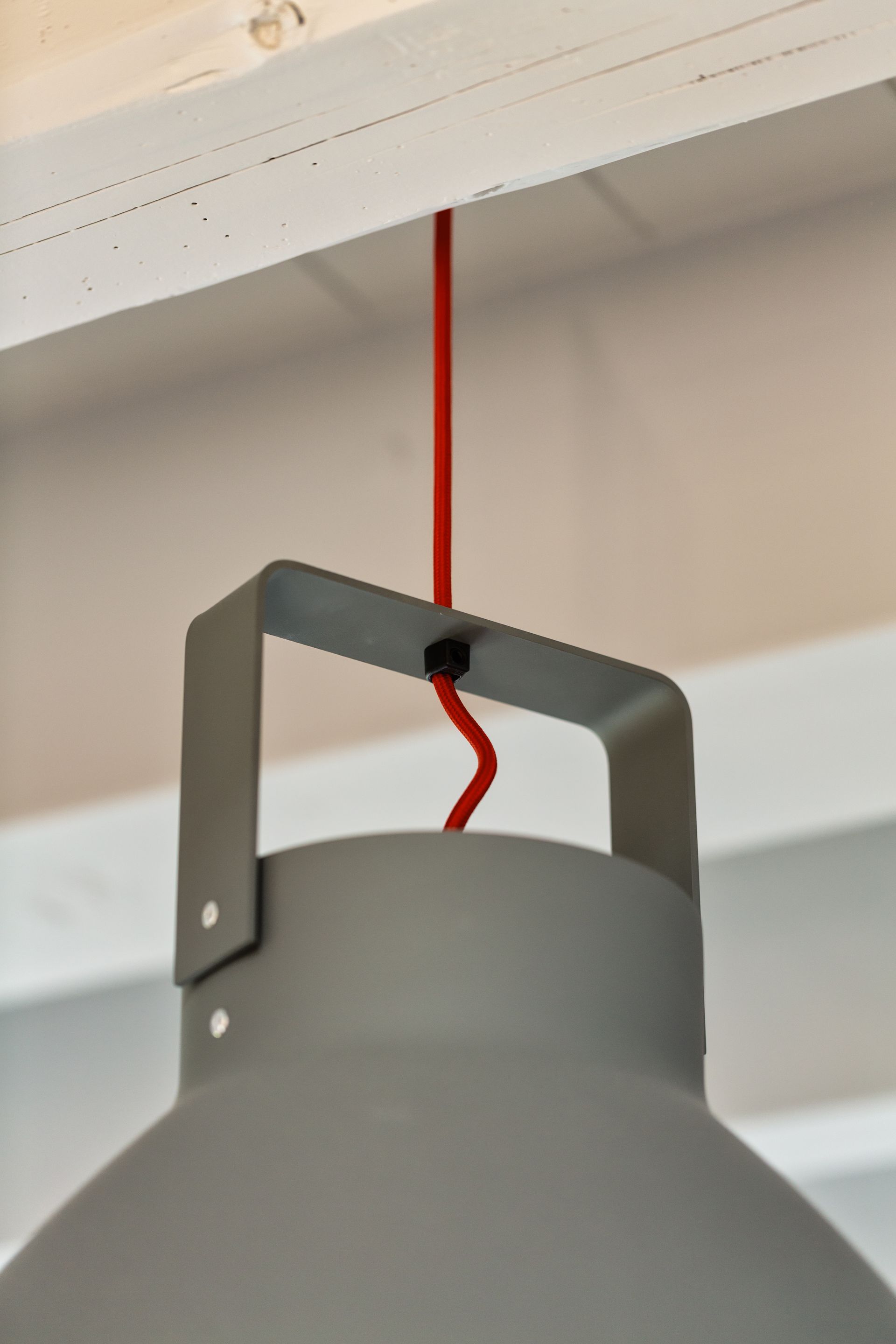 A light hanging from the ceiling with a red cord