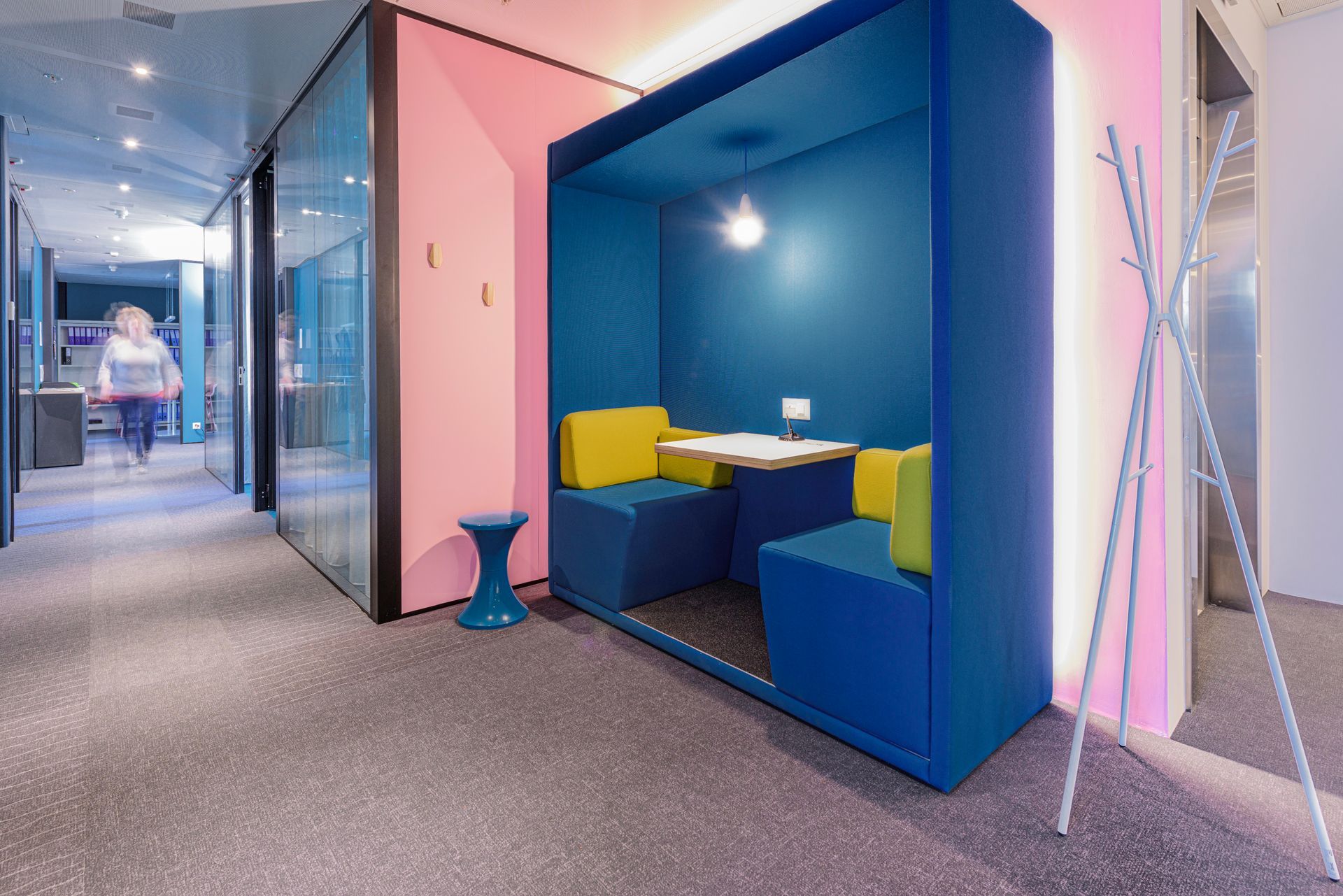 A blue and pink room with a table and chairs in it.