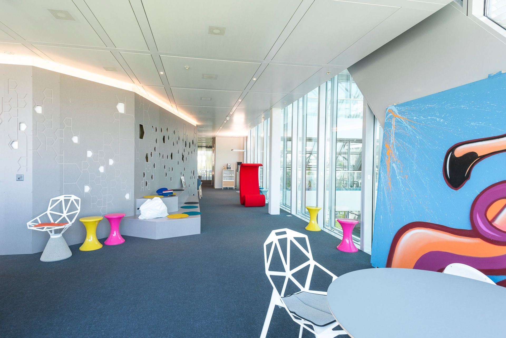 A room with a table and chairs and a mural on the wall