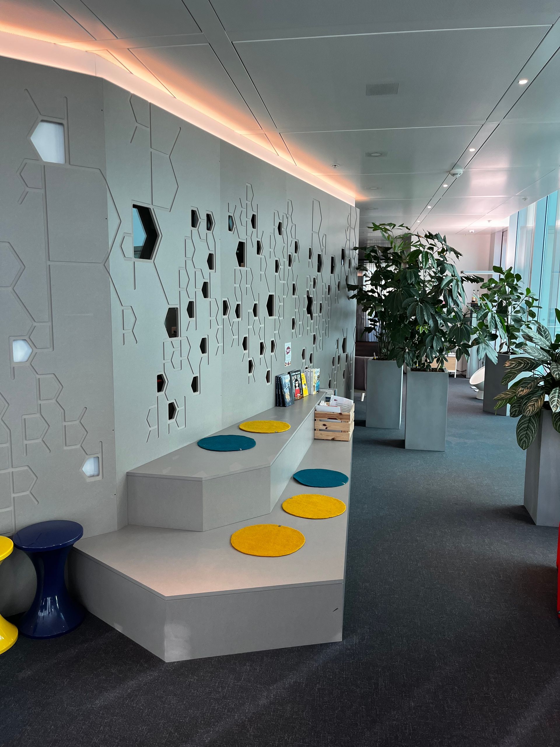 A hallway with a few steps and a few stools