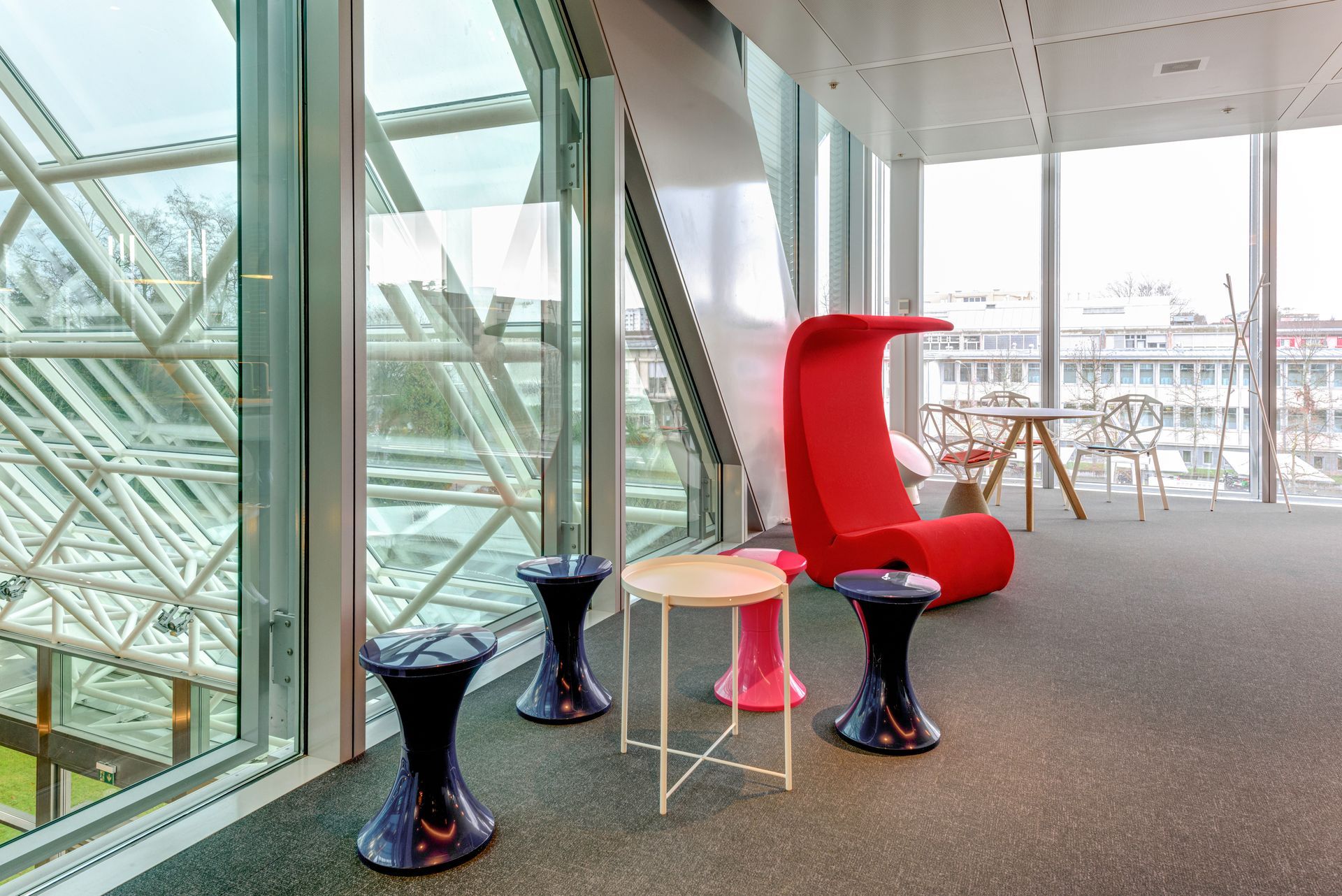 A room with a lot of windows and chairs and tables